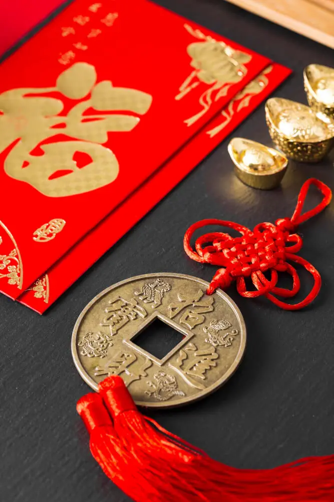 Chinese new year coin and tassel on a red background representing the auspicious traditions of Metaphysics Academy. Chinese new year coin and tassel on a red background representing the auspicious traditions of Metaphysics Academy.